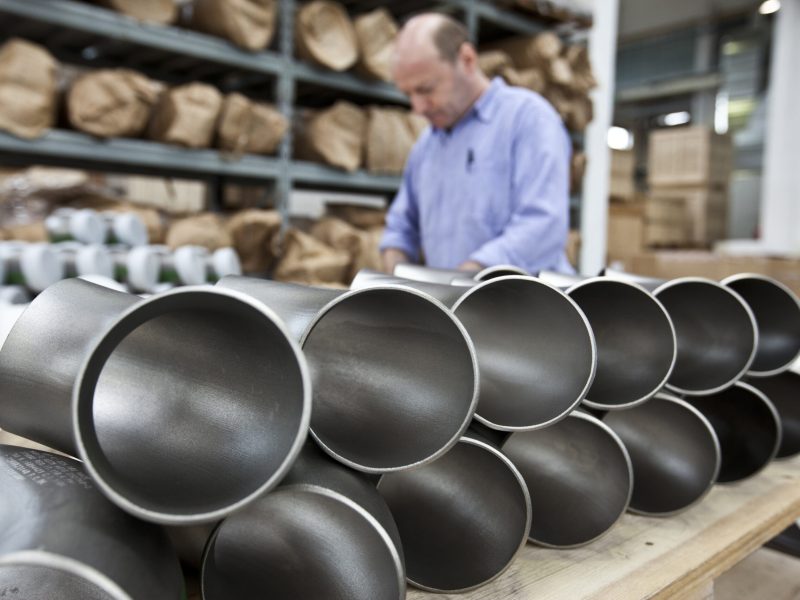 A focused craftsman inspecting products in a workshop